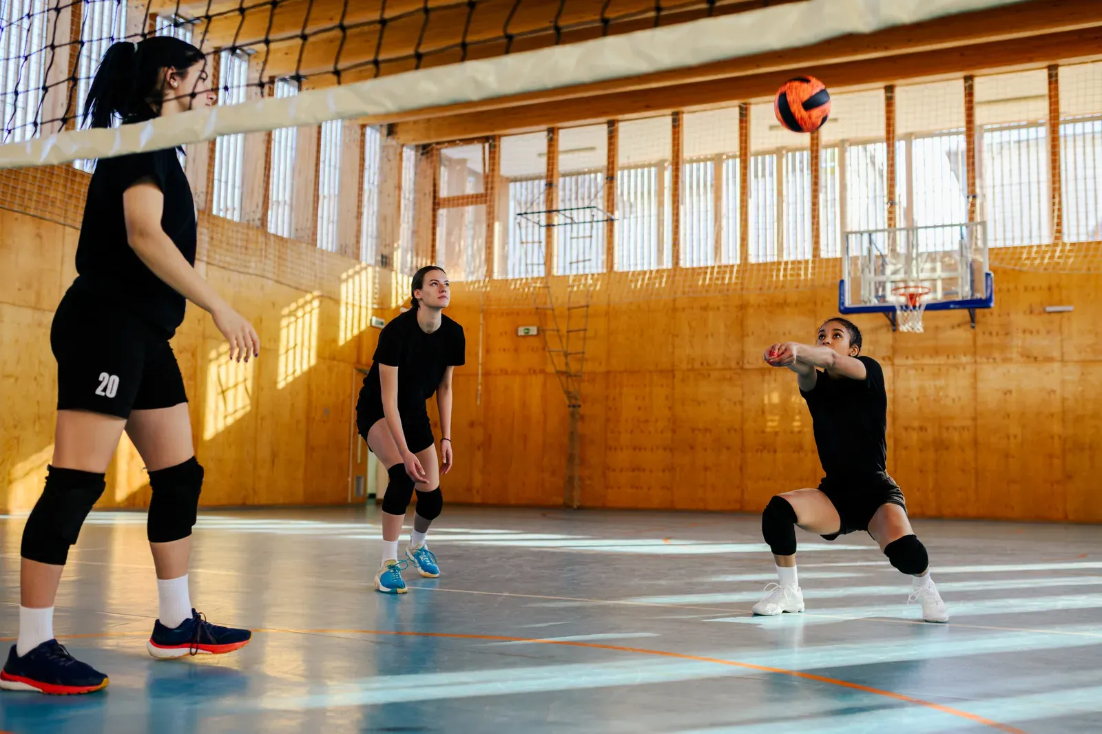 Volleyball player at the top of a jump preparing to attack over the net